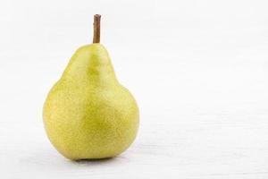green pears on white wooden background photo