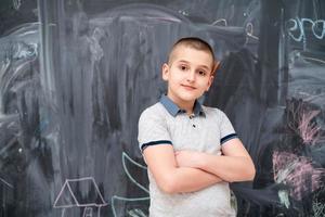 portrait of little boy in front of chalkboard photo