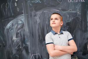 portrait of little boy in front of chalkboard photo