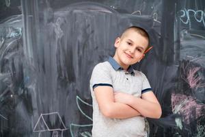 portrait of little boy in front of chalkboard photo