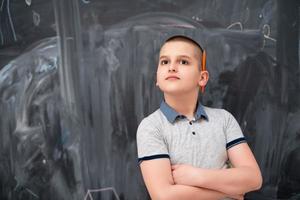 portrait of little boy in front of chalkboard photo