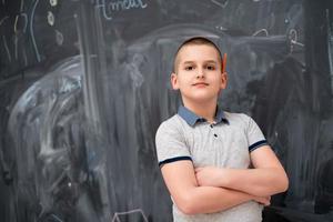 portrait of little boy in front of chalkboard photo