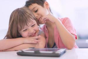 cute little brother and sister having fun at home photo