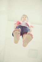 little boy standing on transparent glass floor photo