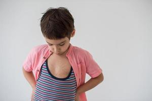 lilittle boy looking at heart love symbol sketched on his chest photo