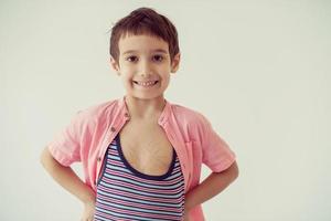 lilittle boy looking at heart love symbol sketched on his chest photo