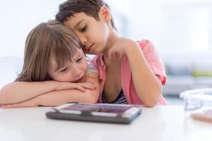 cute little brother and sister having fun at home photo