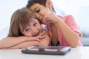 cute little brother and sister having fun at home photo