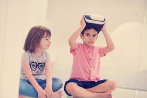 niños usando cascos de realidad virtual en casa foto