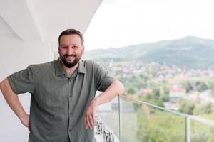 man standing on a modern balcony photo