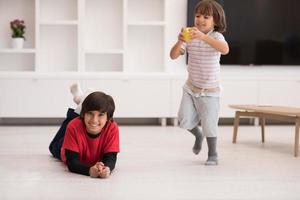 boys having fun with an apple on the floor photo