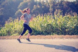 woman jogging along a country road photo