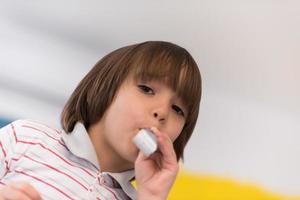 kid blowing a noisemaker photo