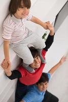 young boys posing line up piggyback top view photo