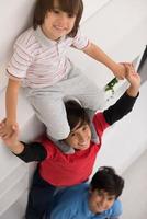 young boys posing line up piggyback top view photo