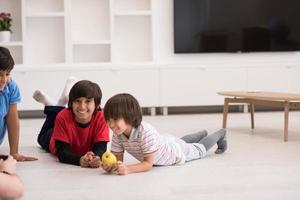 boys having fun with an apple on the floor photo