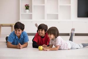 boys having fun with an apple on the floor photo