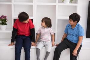 young boys posing on a shelf photo