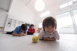 boys having fun with an apple on the floor photo