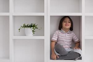 young boy posing on a shelf