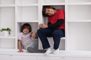 young boys posing on a shelf photo