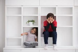 young boys posing on a shelf photo