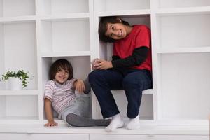 young boys posing on a shelf photo