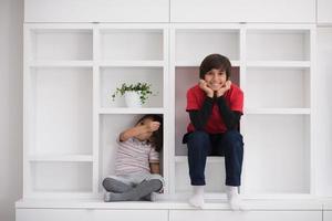 young boys posing on a shelf photo