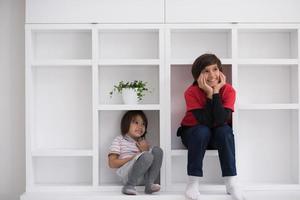 young boys posing on a shelf photo