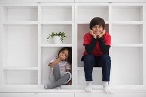 young boys posing on a shelf photo