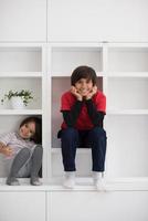 young boys posing on a shelf photo