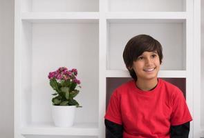 young boy posing on a shelf photo