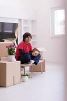 boy sitting on the table with cardboard boxes around him photo