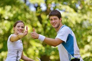 Happy couple riding bicycle outdoors photo