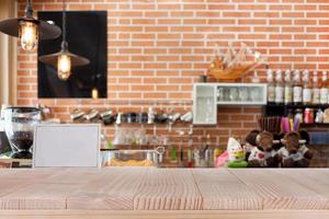 Wood table top on abstract blurred coffee shop background - can be used for montage or display your products photo