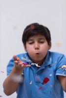 kid blowing confetti photo