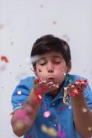 kid blowing confetti photo