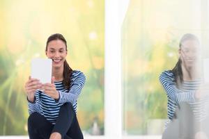 young women using tablet computer on the floor photo