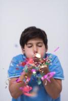 kid blowing confetti photo