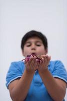 kid blowing confetti photo