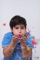 kid blowing confetti photo