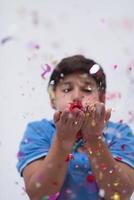 kid blowing confetti photo