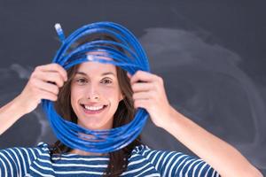 woman holding a internet cable in front of chalk drawing board photo