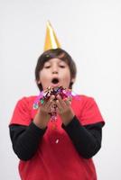 kid blowing confetti photo