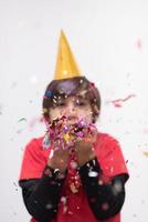 kid blowing confetti photo