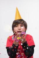 kid blowing confetti photo