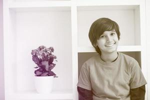 young boy posing on a shelf photo