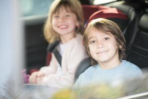 kids  sitting together in modern car photo