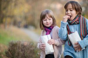 kids in park eating popcorn in park photo