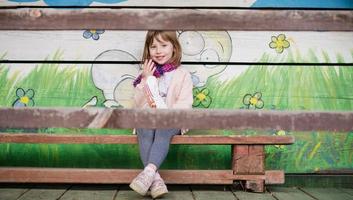 cute little girl  having fun in playground photo